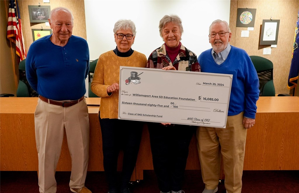 Members of the Class of 1962 reunion committee stand with a big check to present to the education foundation.