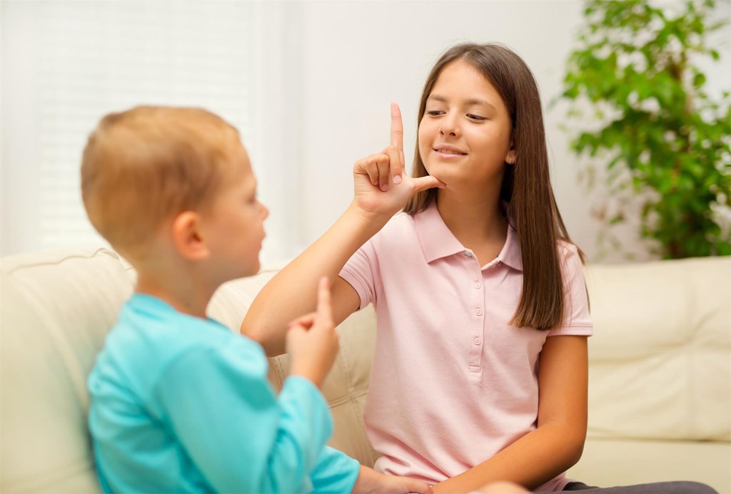 Two children using sign language