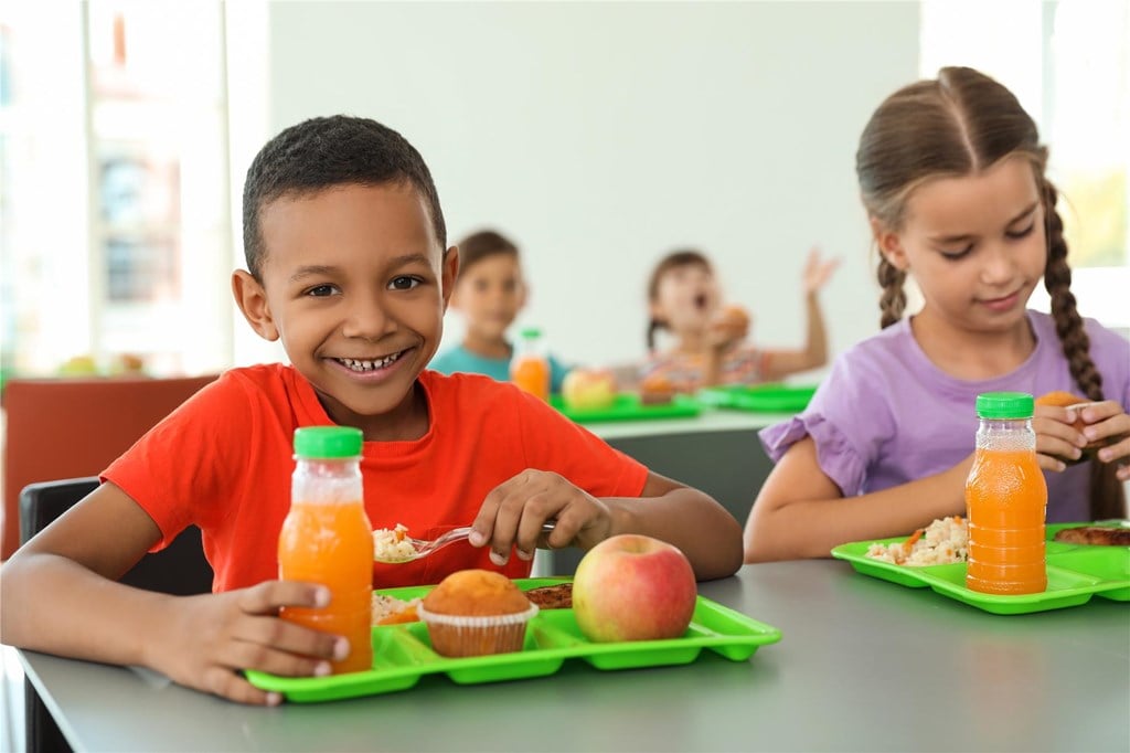 Stock photo of students eating lunch.