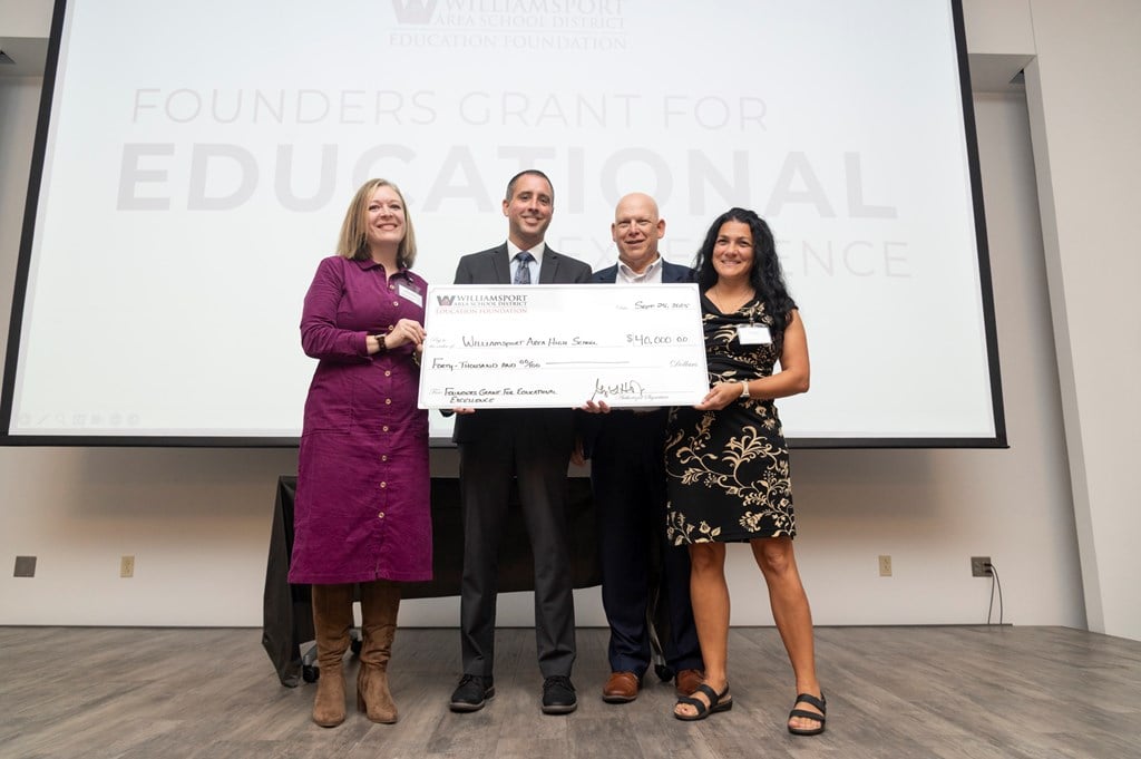 A check presentation for the Collaborative Corner at the event.