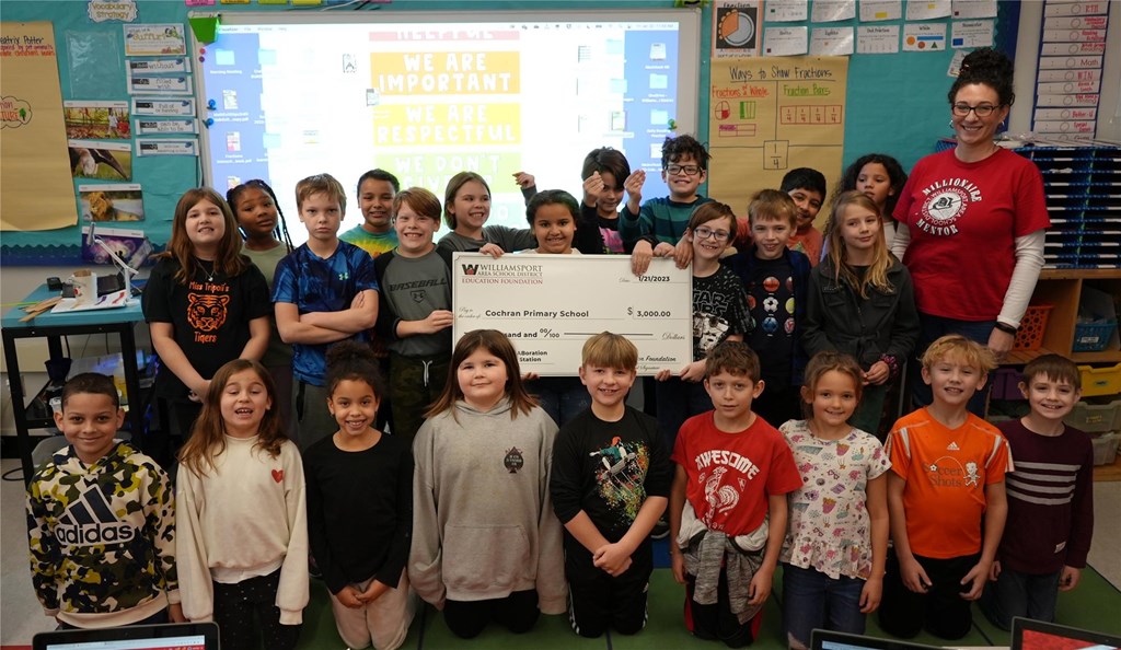 Brooke Nenadal and her students stand with the $3,000 check.