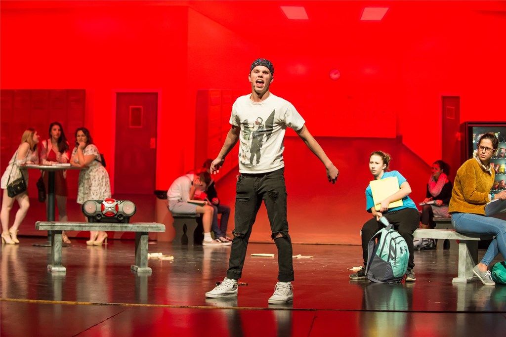 Students onstage performing in a musical