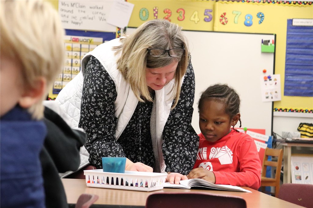 Mrs. McClain working with a kindergarten student.