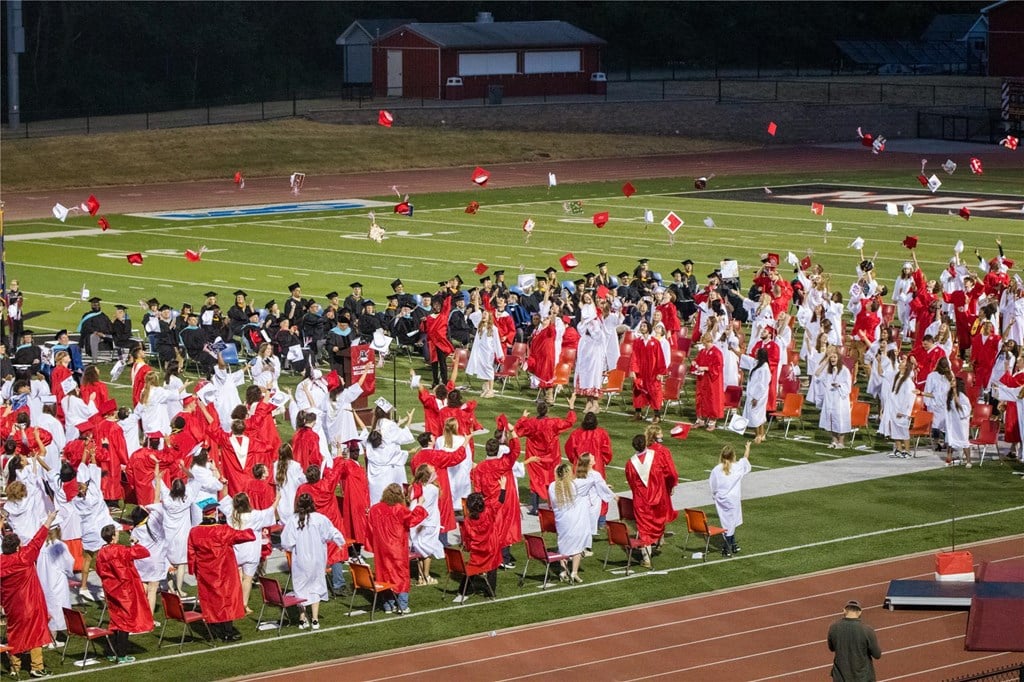 Members of the Class of 2023 toss their caps at the end of the graduation ceremony.