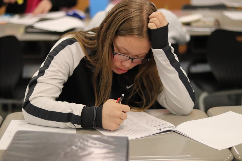 Student works on an English packet.