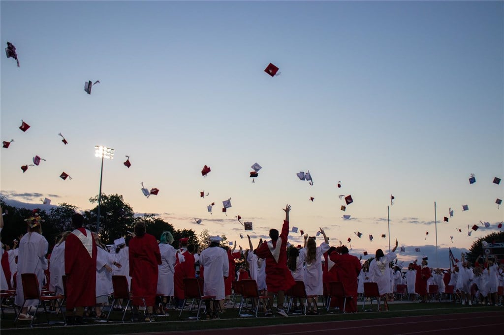 Students toss their caps during the 2022 graduation ceremony.