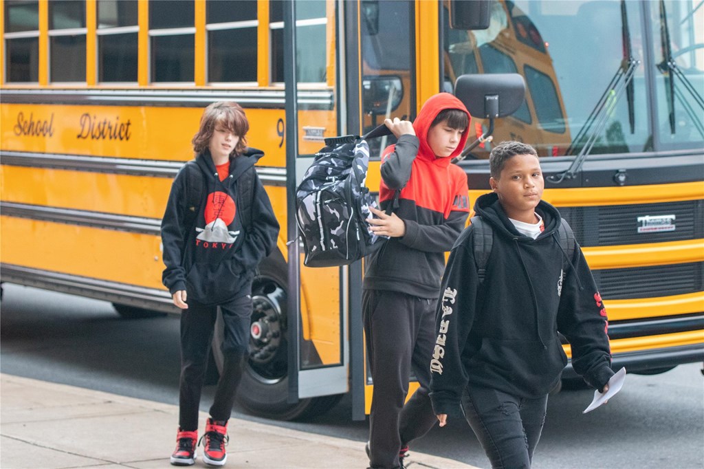 Students walk off the bus at WAHS.