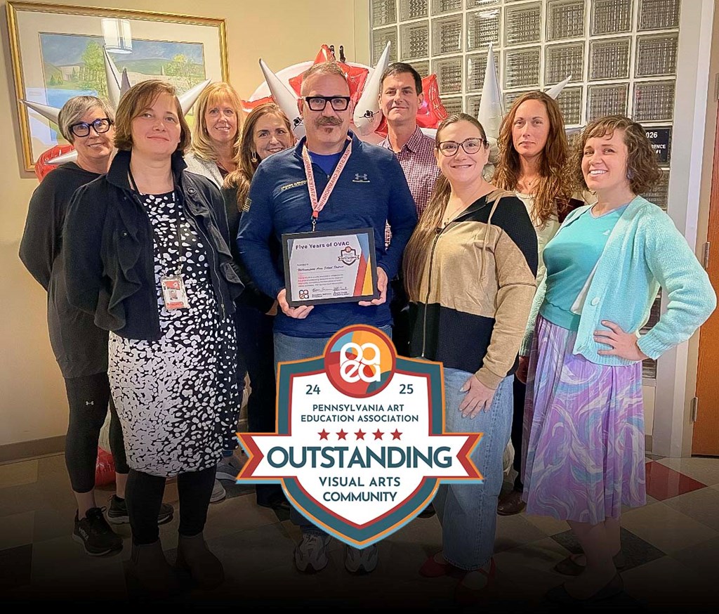 The WASD art department faculty stand with their certificate.