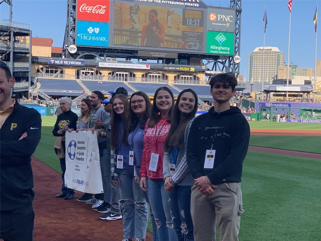 Students stand on the field at PNC Park.
