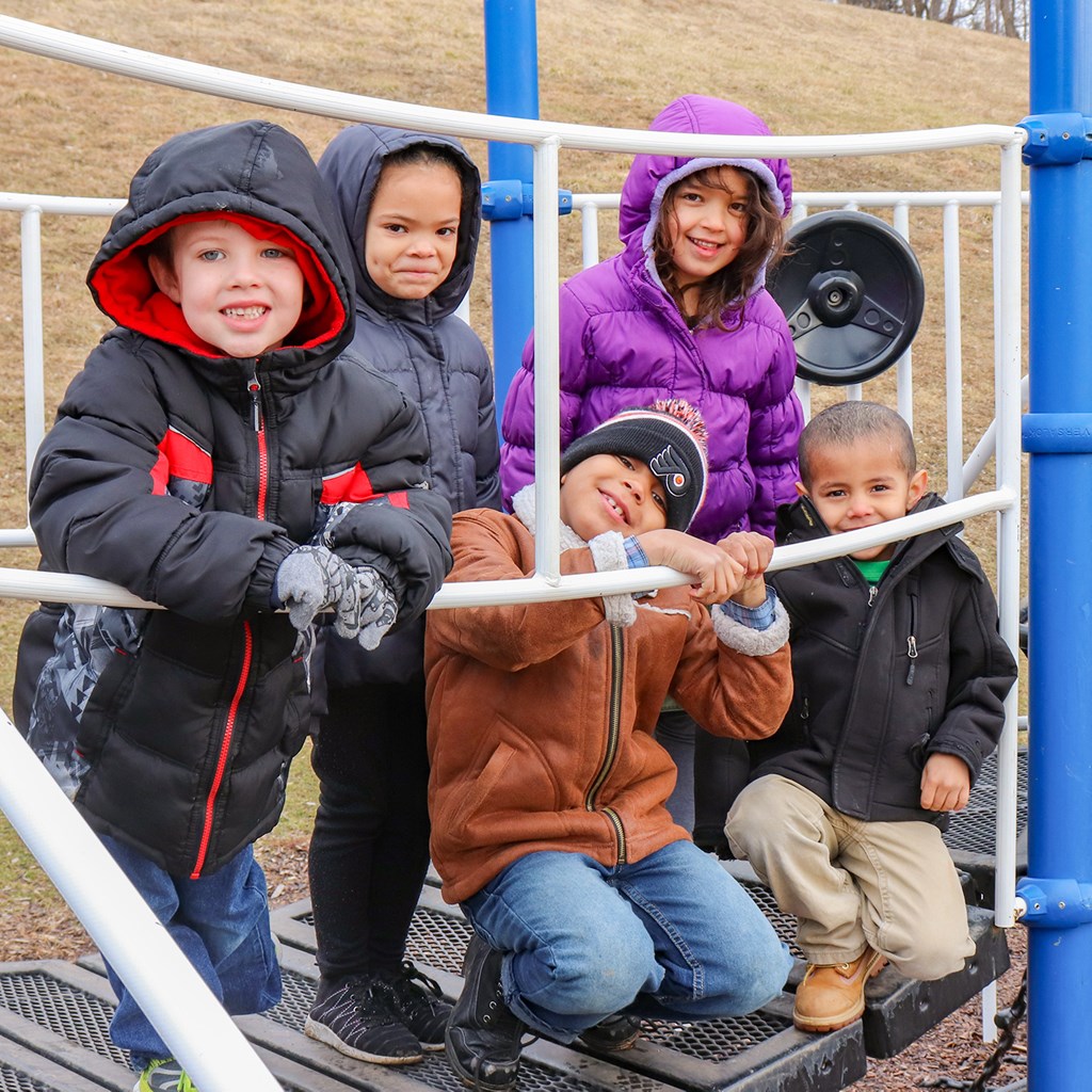 Students playing on play set
